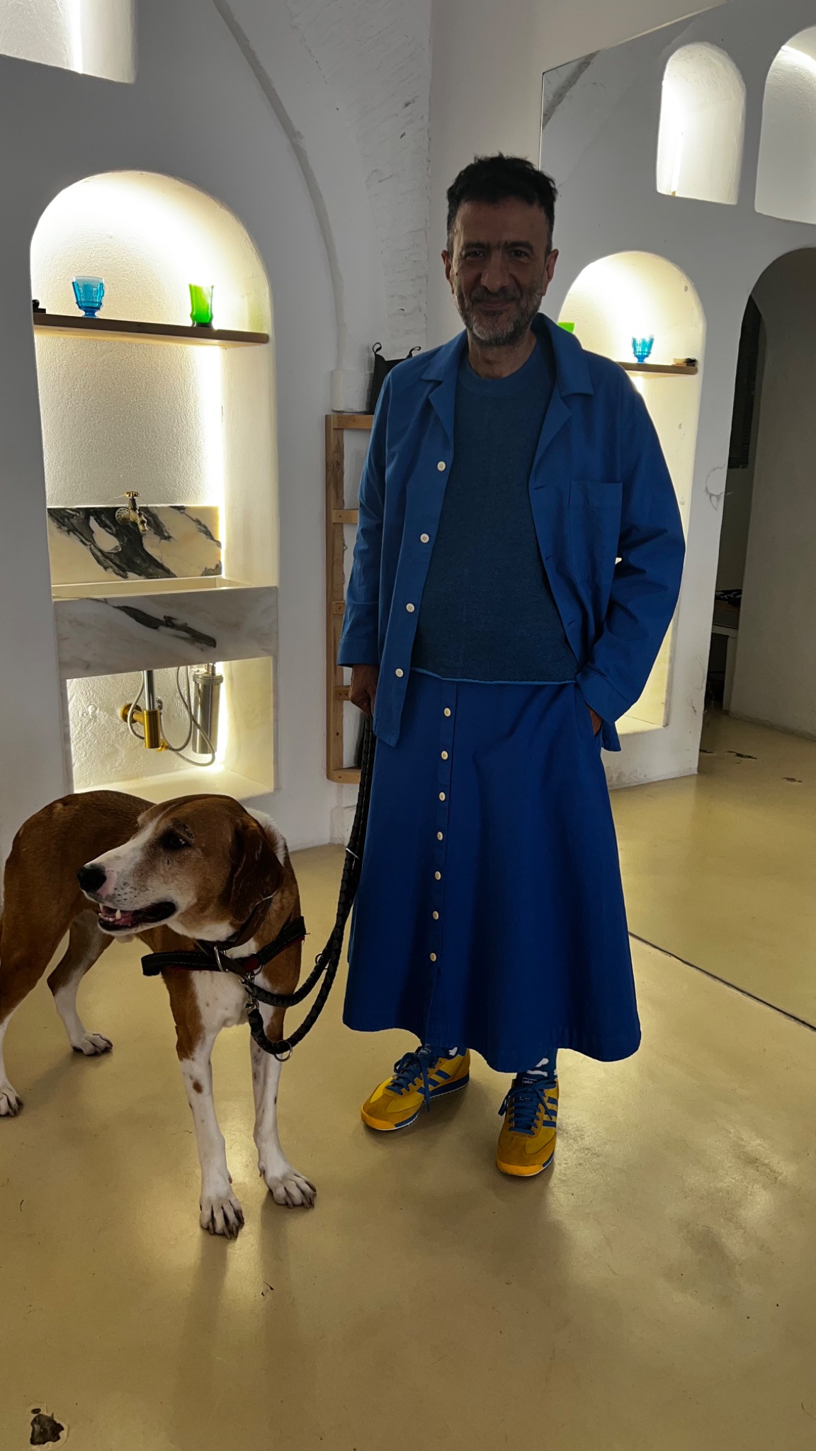 Vitor Rua in blue with a dog